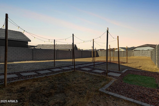 view of yard at dusk