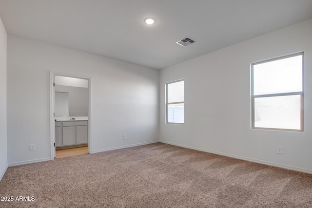 spare room with light colored carpet