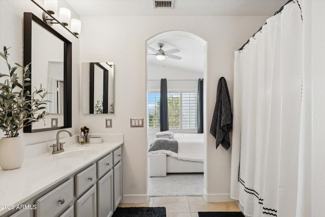 10252 E Butherus Dr, Scottsdale, AZ 85255 - ensuite bathroom featuring a ceiling fan, vanity, tile patterned floors, and lofted ceiling