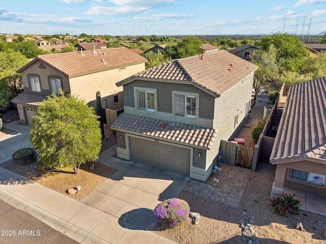 10252 E Butherus Dr, Scottsdale, AZ 85255 - view of front of home featuring stucco siding, a garage, driveway, a tile roof, and a residential view