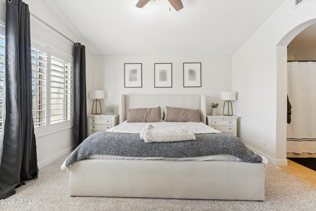 10252 E Butherus Dr, Scottsdale, AZ 85255 - bedroom featuring arched walkways, multiple windows, vaulted ceiling, and ceiling fan
