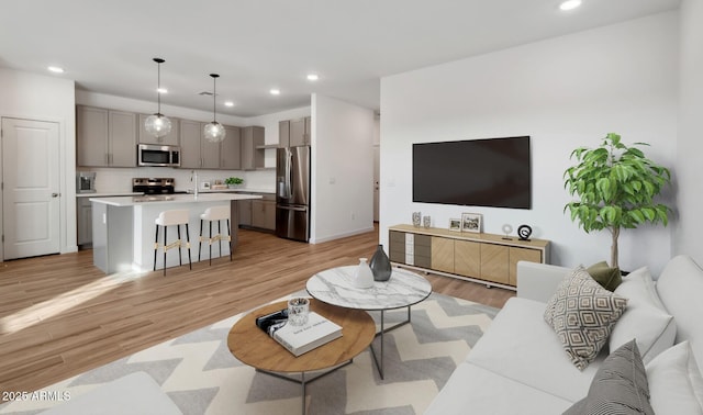 living area with recessed lighting and light wood-style flooring