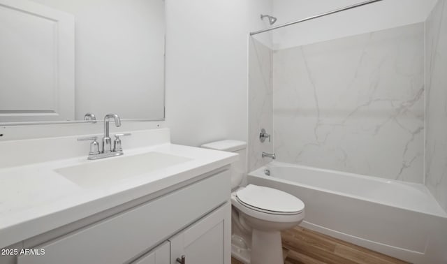 bathroom with vanity, toilet, shower / tub combination, and wood finished floors