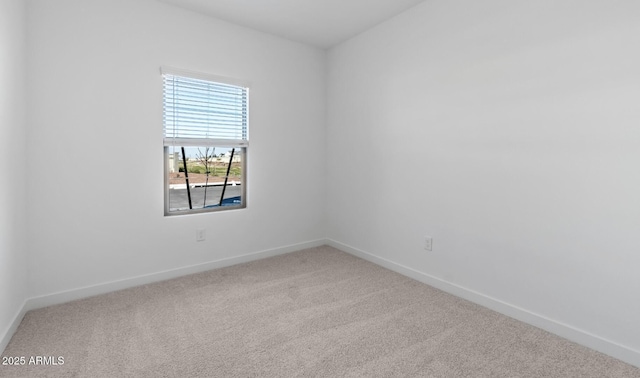 carpeted empty room with baseboards