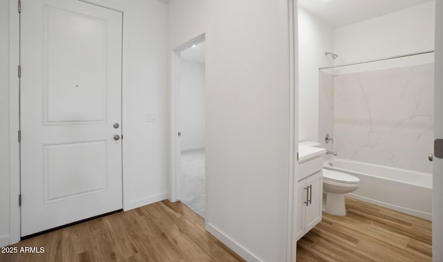 bathroom with vanity, shower / bathing tub combination, toilet, and wood finished floors