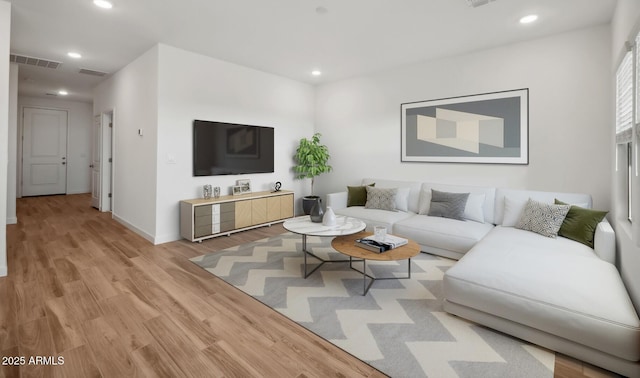 living area featuring recessed lighting, visible vents, and light wood-style floors