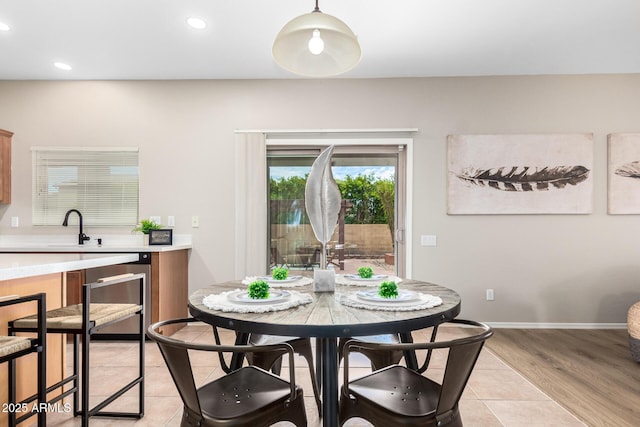 tiled dining area featuring sink