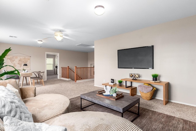 carpeted living room with ceiling fan