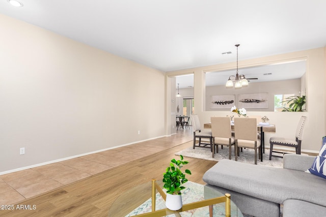 living room with a chandelier and hardwood / wood-style floors