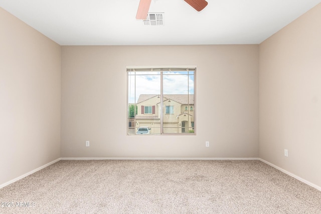 carpeted empty room featuring ceiling fan