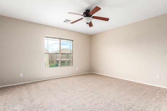 carpeted empty room featuring ceiling fan