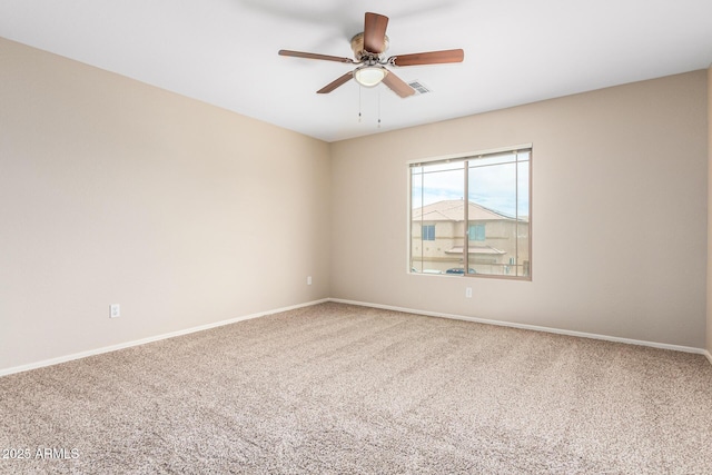 carpeted empty room featuring ceiling fan