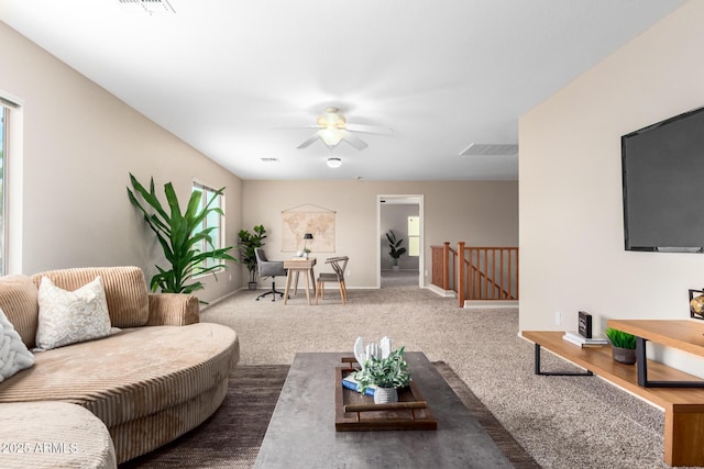 living room with ceiling fan and carpet