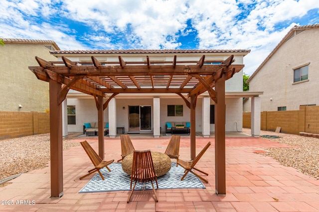 back of property with an outdoor hangout area, a patio area, and a pergola