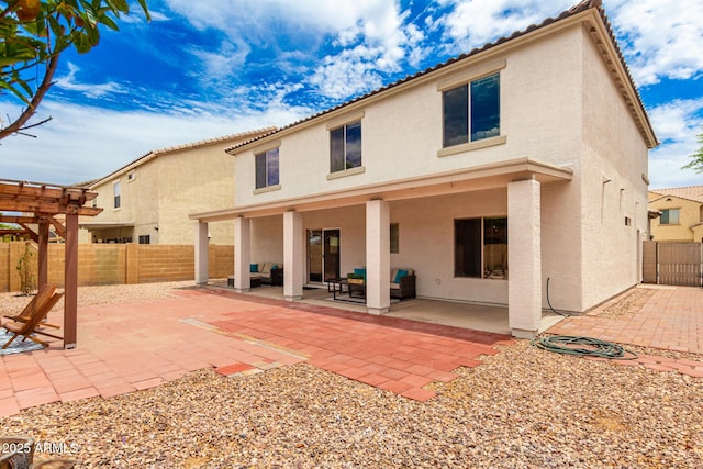 back of house with a pergola, a patio area, and outdoor lounge area