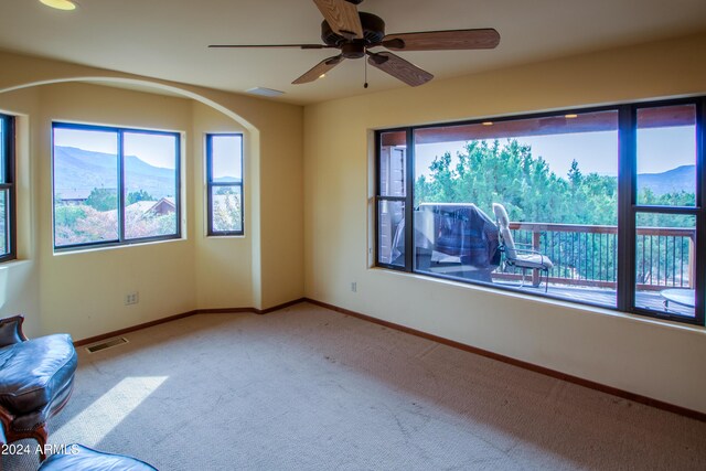 6641 W Wolfpaw Ln, Pine, AZ 85544 - empty room featuring plenty of natural light, carpet, and a ceiling fan
