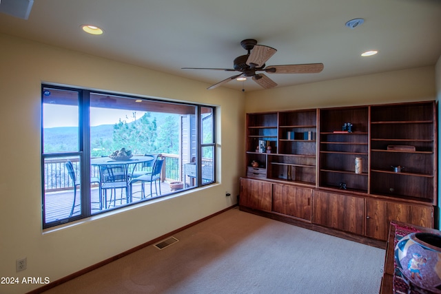 interior space with ceiling fan and a mountain view