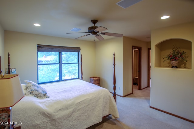 bedroom with ceiling fan and light carpet