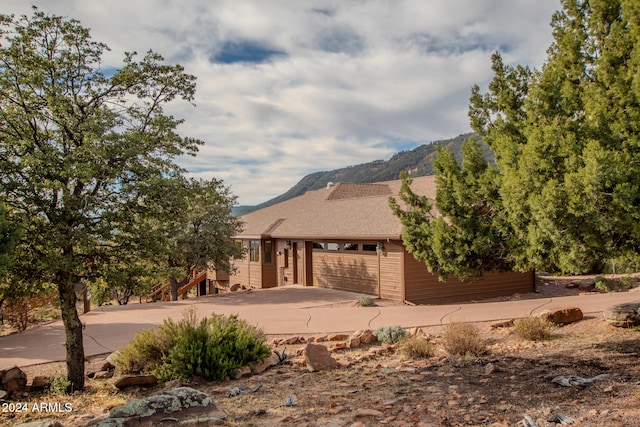 view of front of property with a mountain view and a garage