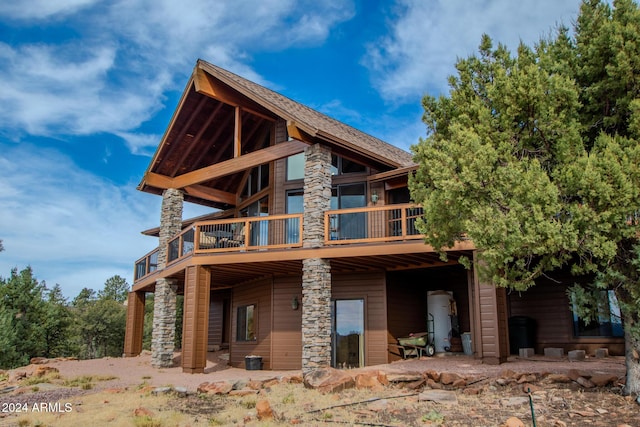 6641 W Wolfpaw Ln, Pine, AZ 85544 - back of property with stone siding, a deck, and gas water heater