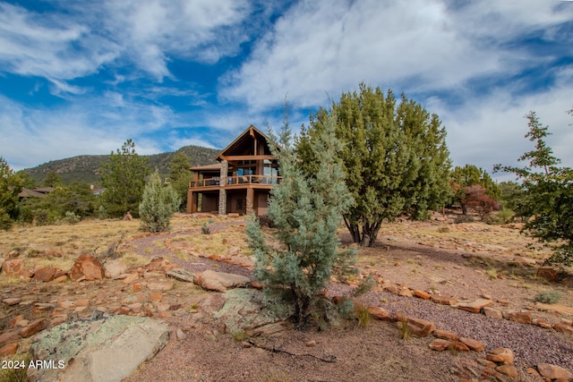 rear view of house featuring a deck with mountain view