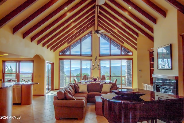 6641 W Wolfpaw Ln, Pine, AZ 85544 - living room with high vaulted ceiling, beam ceiling, tile patterned flooring, a tile fireplace, and ceiling fan
