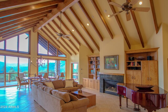 6641 W Wolfpaw Ln, Pine, AZ 85544 - living area featuring a ceiling fan, beam ceiling, light tile patterned floors, a tiled fireplace, and high vaulted ceiling