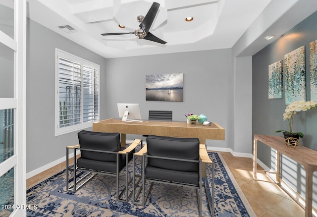 office featuring ceiling fan, a raised ceiling, and tile patterned flooring