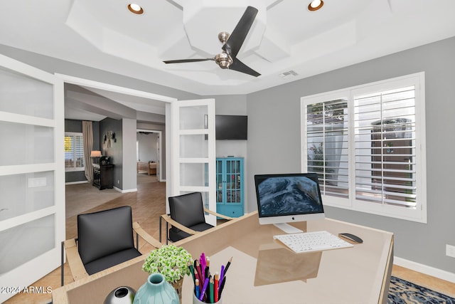 tiled office featuring a raised ceiling, ceiling fan, built in features, and french doors