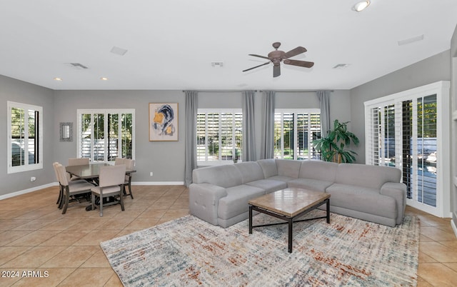 tiled living room featuring ceiling fan and a wealth of natural light