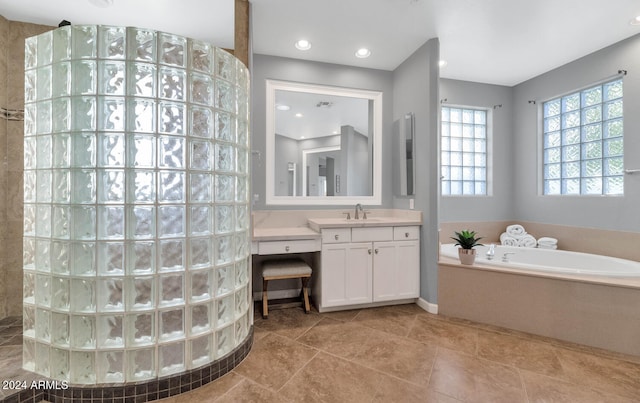 bathroom with separate shower and tub and vanity