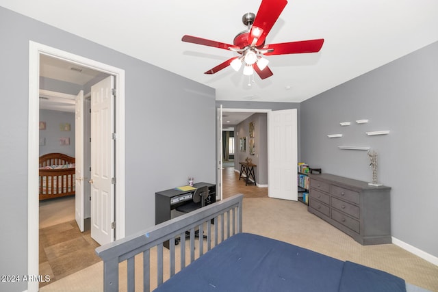 bedroom with ceiling fan and light carpet