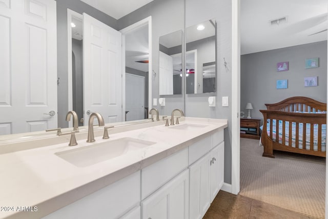 bathroom with ceiling fan, tile patterned flooring, and vanity