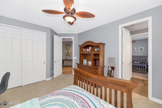 bedroom with a closet, light colored carpet, and ceiling fan