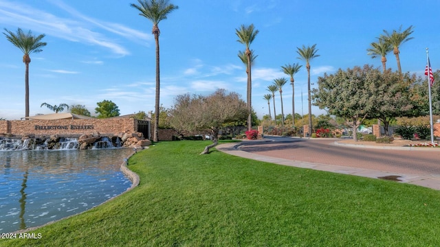 exterior space featuring a water view and a yard