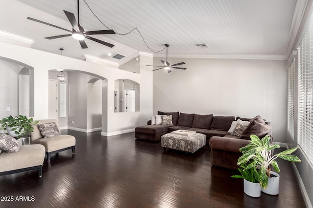 living area featuring crown molding, arched walkways, ceiling fan, and vaulted ceiling