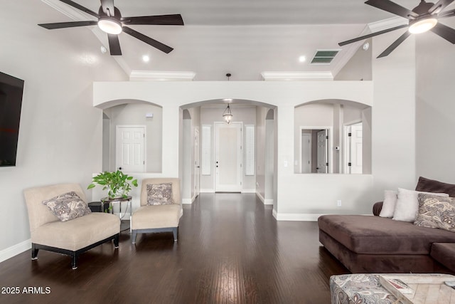 living area featuring baseboards, a ceiling fan, wood finished floors, and ornamental molding