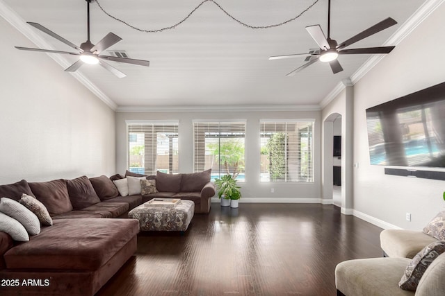 living room featuring a ceiling fan, dark wood-style flooring, arched walkways, baseboards, and ornamental molding