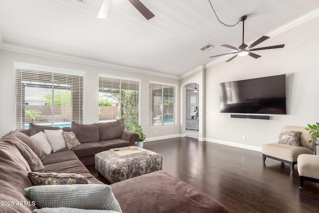 living room featuring a ceiling fan, dark wood-style flooring, visible vents, crown molding, and baseboards