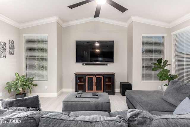 living area with ceiling fan, wood finished floors, baseboards, lofted ceiling, and ornamental molding