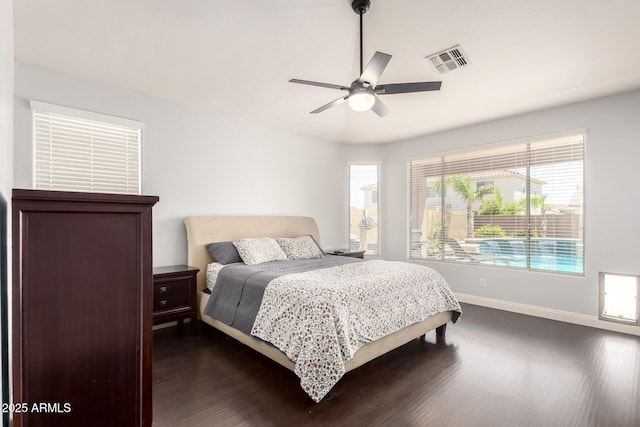 bedroom featuring baseboards, ceiling fan, dark wood-style floors, and visible vents