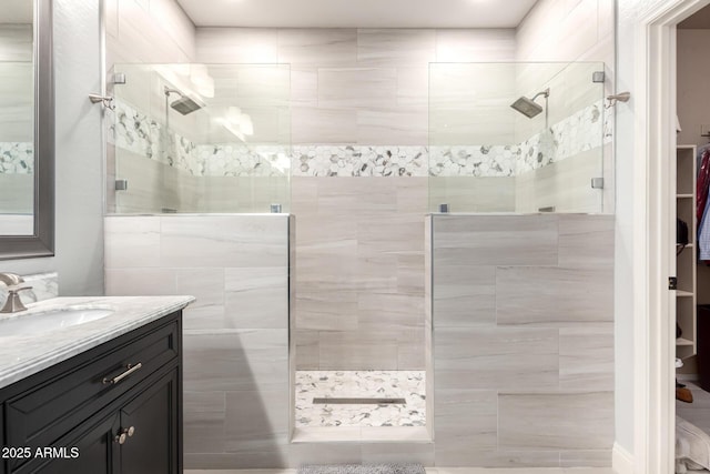 full bath with a walk in shower and vanity