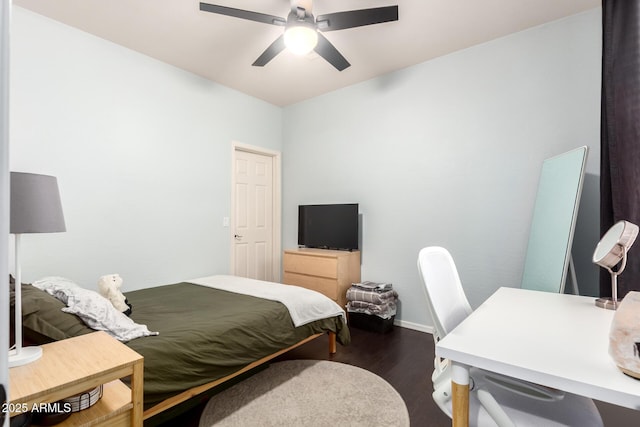 bedroom featuring a ceiling fan, baseboards, and dark wood-type flooring