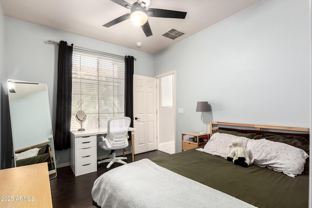 bedroom with visible vents, dark wood finished floors, ceiling fan, and baseboards