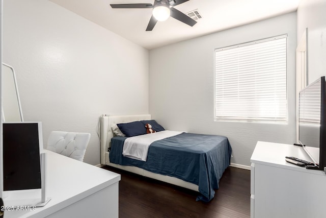 bedroom with baseboards, a ceiling fan, dark wood-style flooring, and visible vents
