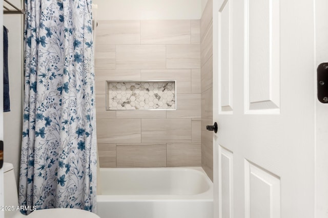 bathroom with shower / bath combo and toilet