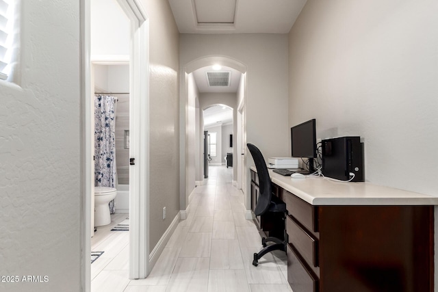 office area featuring arched walkways and visible vents