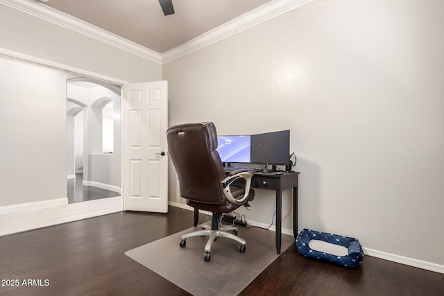 home office with arched walkways, baseboards, ornamental molding, and wood finished floors