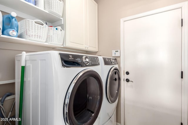 laundry area featuring washer and dryer and cabinet space