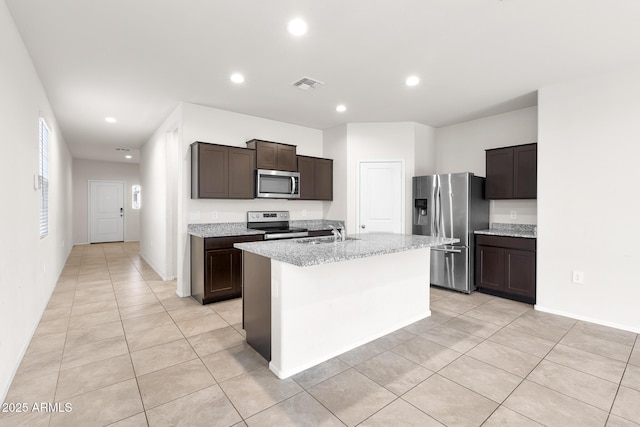 5269 E Gummite Dr, San Tan Valley, AZ 85143 - kitchen featuring visible vents, stainless steel appliances, dark brown cabinets, a sink, and an island with sink